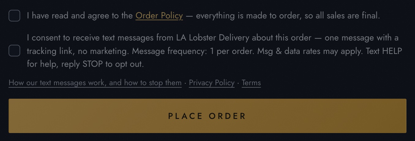 The bottom of the checkout Review step: two unchecked checkboxes — the Order Policy agreement, and below it the single text-message consent quoted in full on this page — then the Place Order button.